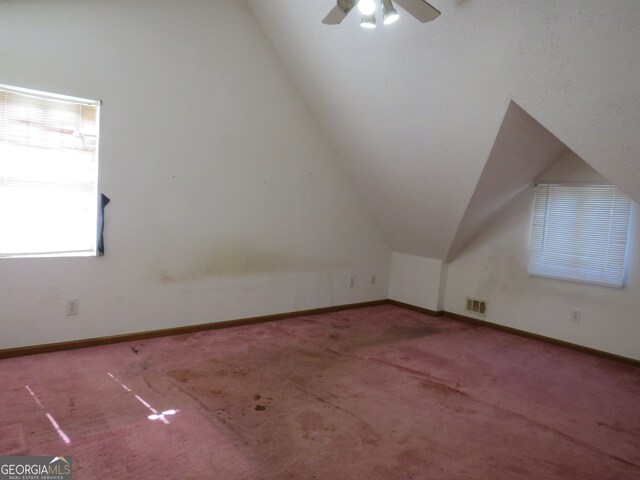 bonus room featuring lofted ceiling, carpet, and ceiling fan