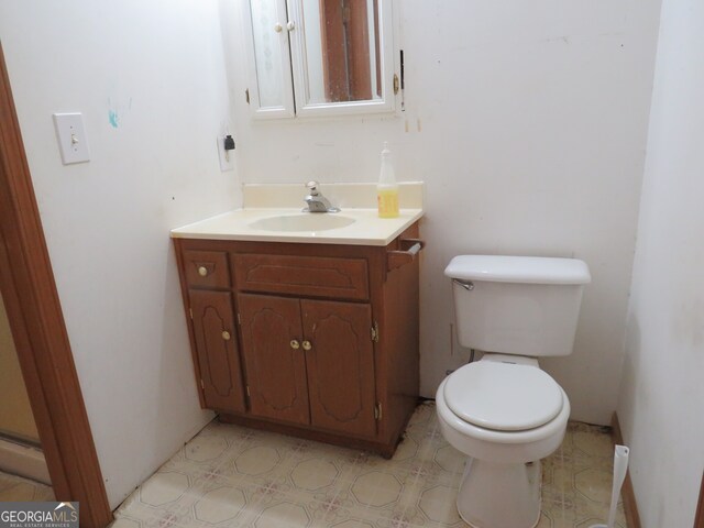 bathroom featuring vanity and toilet