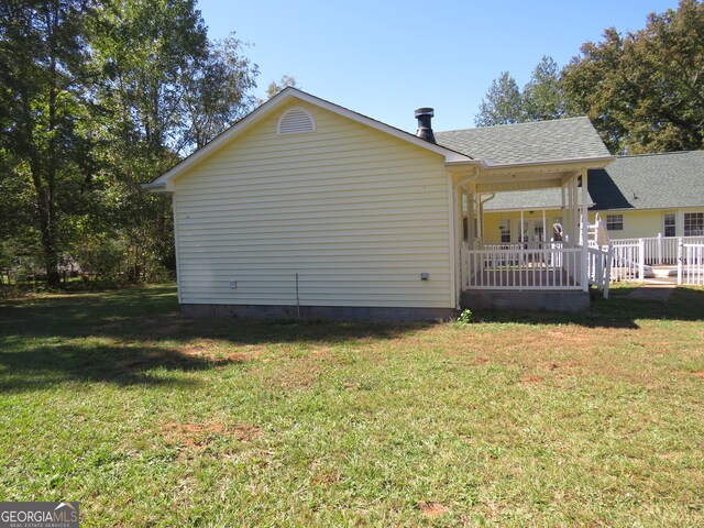 view of property exterior with a yard