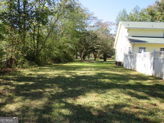 view of yard with central air condition unit