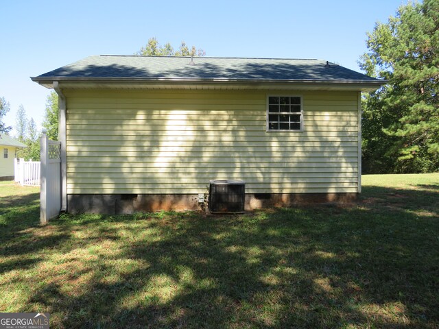 view of home's exterior featuring a yard and central AC