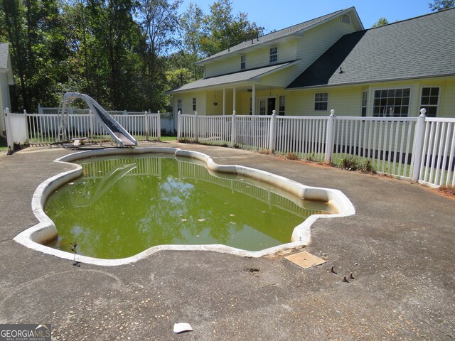 view of swimming pool with a water slide