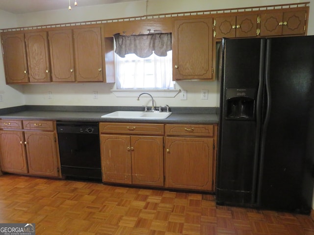 kitchen featuring light parquet flooring, black appliances, and sink