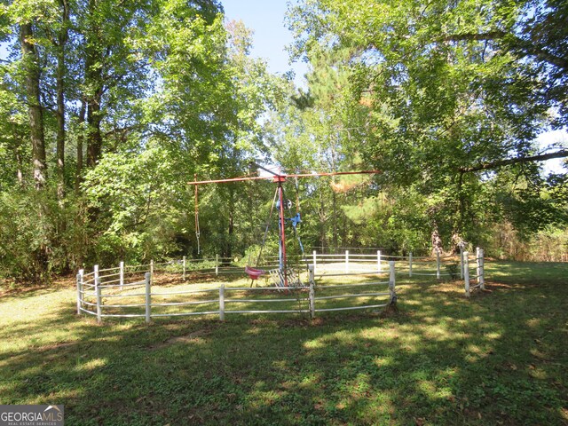 view of playground with a lawn