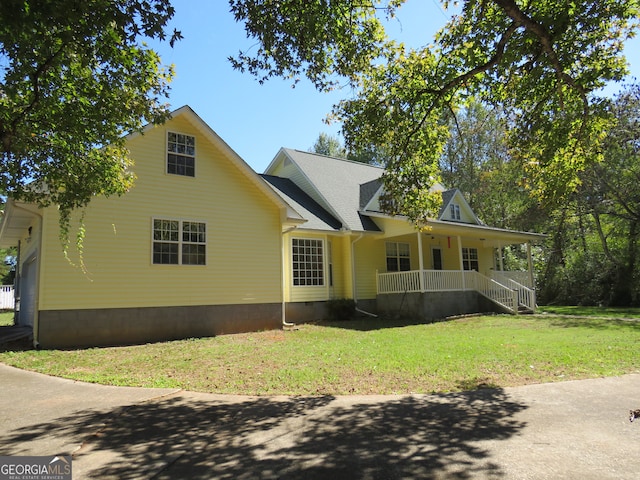 view of front of home with a porch and a front yard