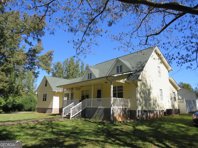 402 Thurman Rd, Stockbridge, GA 30281 - view of front of property featuring a porch, a front lawn, roof with shingles, and central air condition unit