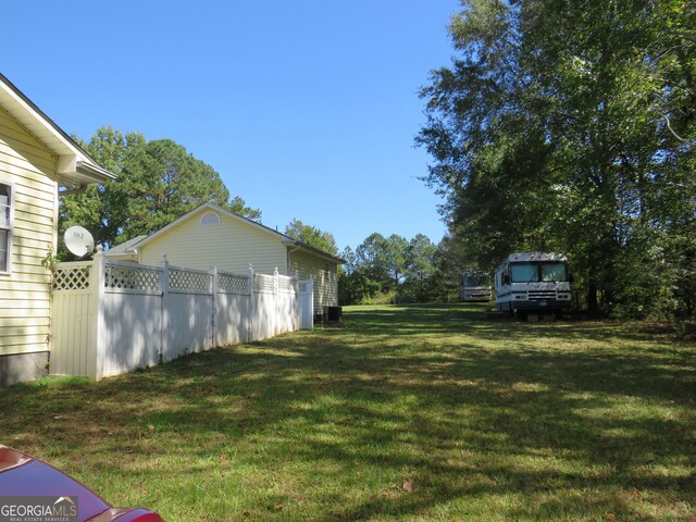 view of yard featuring central air condition unit