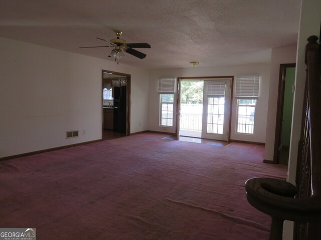 interior space featuring ceiling fan and a textured ceiling