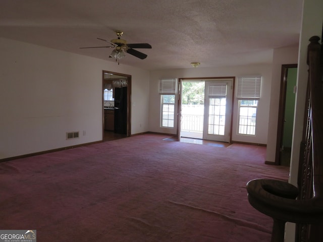 402 Thurman Rd, Stockbridge, GA 30281 - unfurnished living room with carpet, baseboards, ceiling fan, and a sink