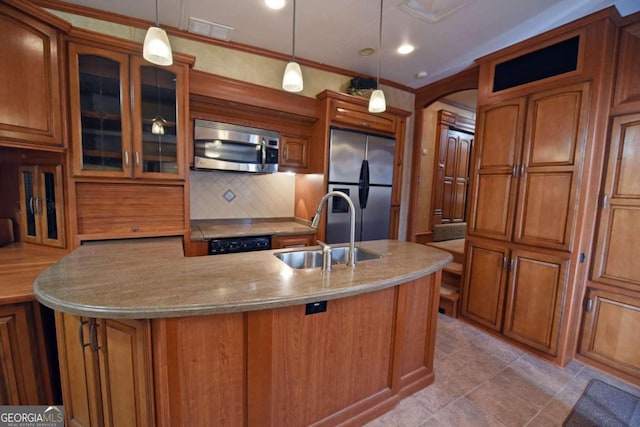 kitchen with stainless steel appliances, sink, crown molding, decorative light fixtures, and backsplash