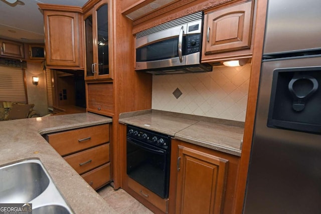 kitchen with appliances with stainless steel finishes and decorative backsplash