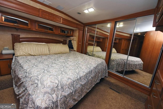 carpeted bedroom with a closet and vaulted ceiling