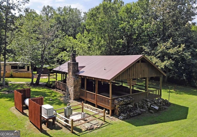 rear view of house featuring a lawn