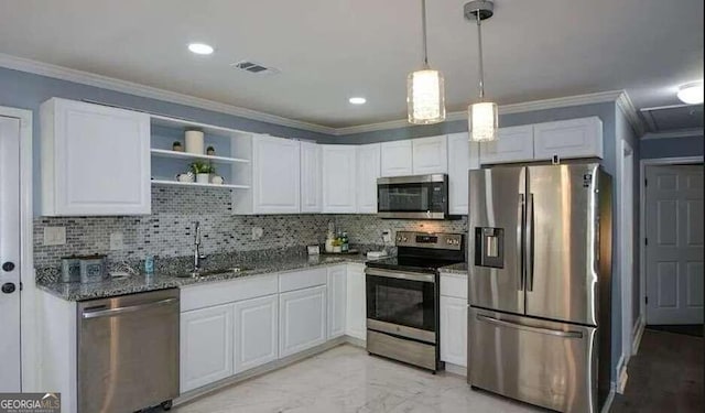 kitchen with appliances with stainless steel finishes, dark stone counters, white cabinetry, and sink