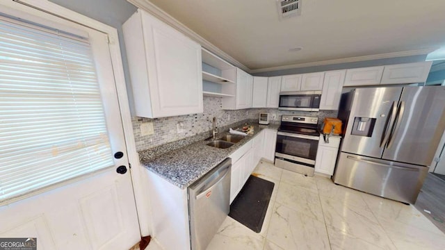 kitchen featuring white cabinets, stainless steel appliances, plenty of natural light, and sink