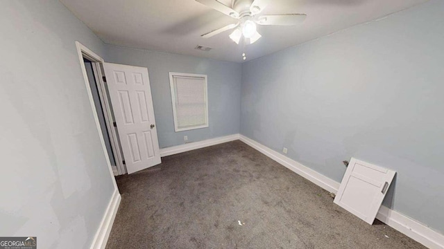 unfurnished bedroom featuring dark carpet and ceiling fan