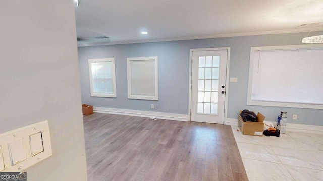 interior space featuring crown molding and light wood-type flooring