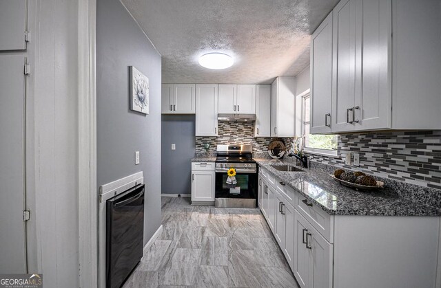 kitchen with white cabinetry, stainless steel range, dark stone counters, crown molding, and decorative backsplash