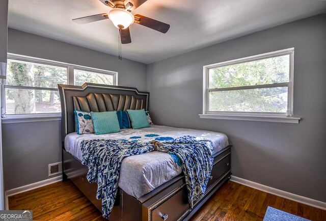 bedroom with ceiling fan and dark wood-type flooring