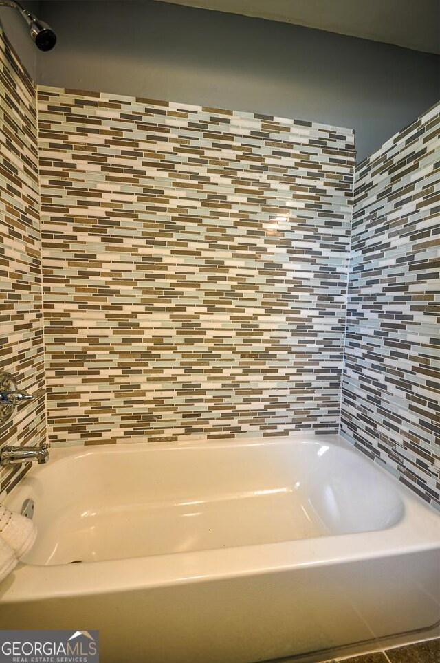 bathroom featuring backsplash, vanity, and tile walls