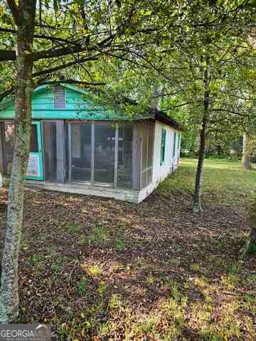 exterior space with a sunroom and an outdoor structure