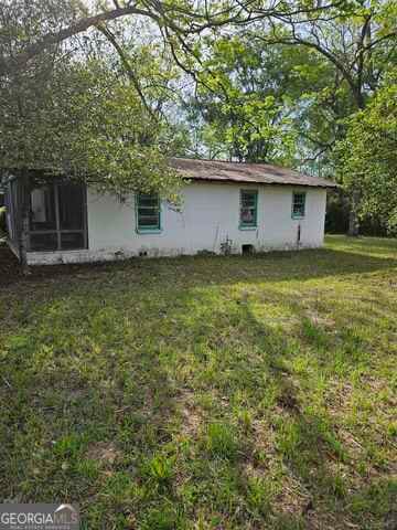 rear view of house with a lawn