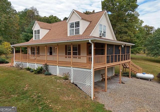 farmhouse inspired home featuring cooling unit, a porch, a front lawn, and a sunroom