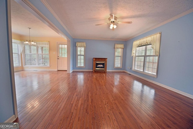 unfurnished living room with plenty of natural light, wood-type flooring, and a textured ceiling