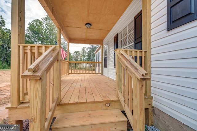 wooden terrace featuring covered porch