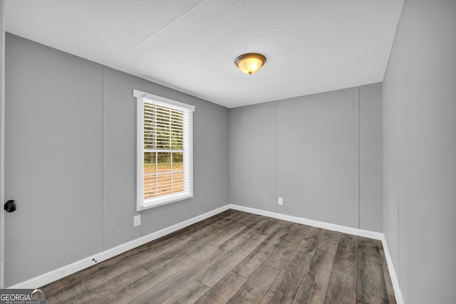 spare room with hardwood / wood-style flooring