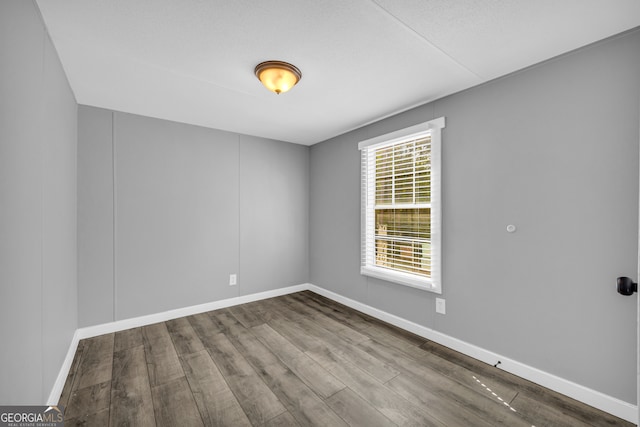 spare room with hardwood / wood-style floors