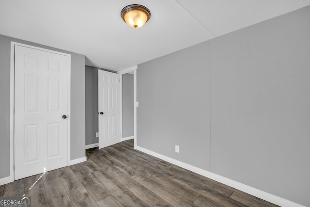 unfurnished bedroom featuring dark hardwood / wood-style flooring