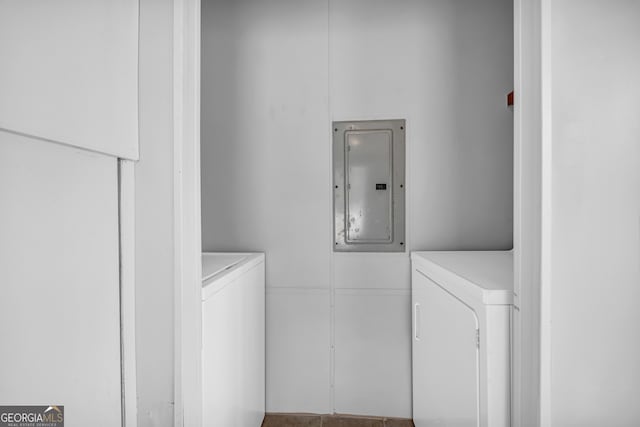 laundry area with electric panel and independent washer and dryer