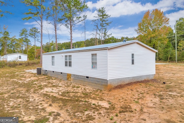 view of side of home featuring cooling unit