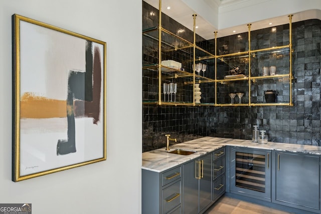 bar with tasteful backsplash, wine cooler, and sink