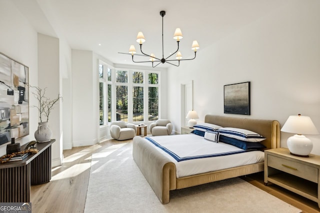 bedroom featuring light hardwood / wood-style floors and an inviting chandelier