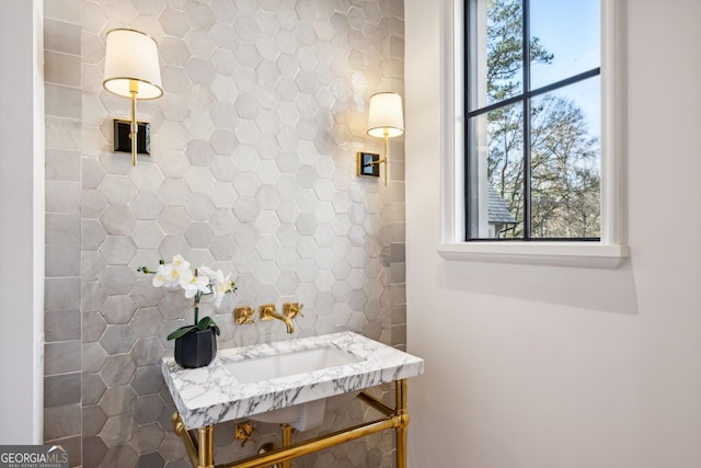 bathroom featuring backsplash and sink