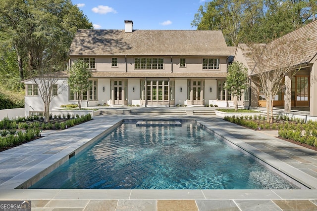 rear view of house with french doors and a patio