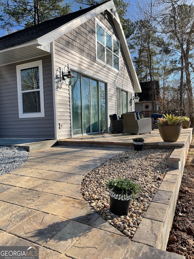 back of house with a patio area and an outdoor living space