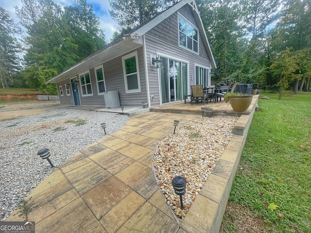 back of house featuring a yard and a patio area