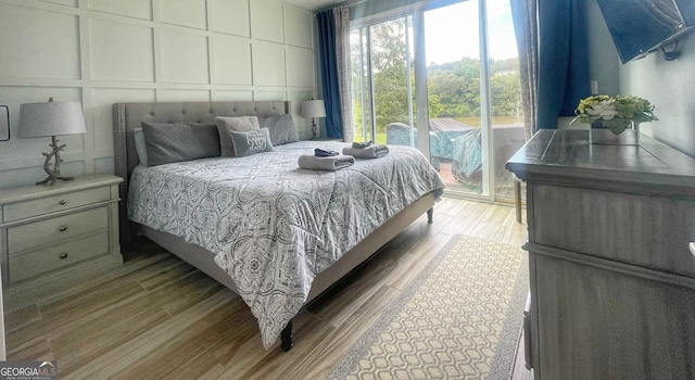 bedroom featuring access to outside and hardwood / wood-style flooring