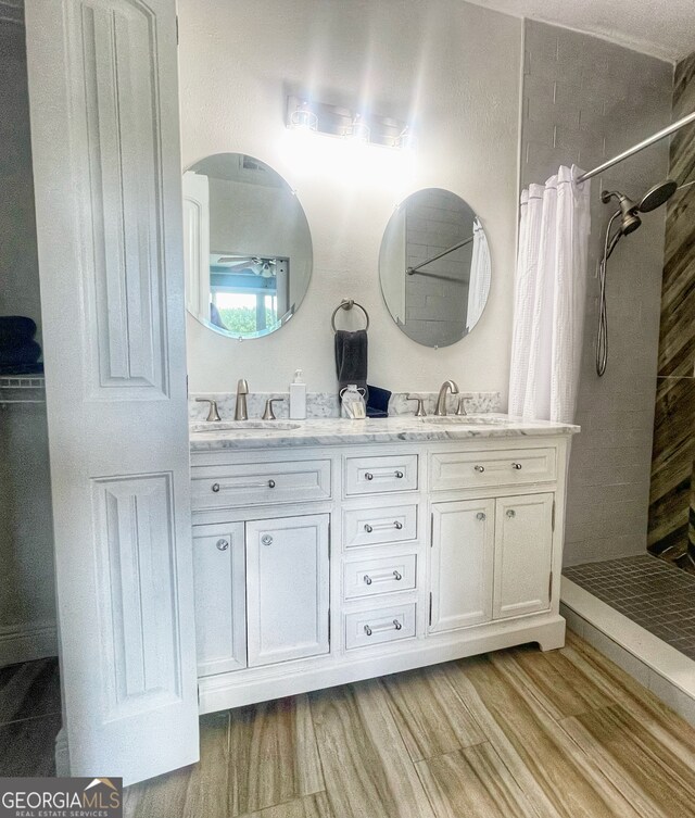 bathroom featuring vanity, a shower with curtain, and wood-type flooring