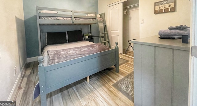 bedroom with a closet and hardwood / wood-style floors