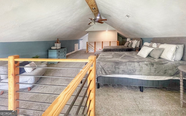 carpeted bedroom with ceiling fan, lofted ceiling with beams, and a textured ceiling