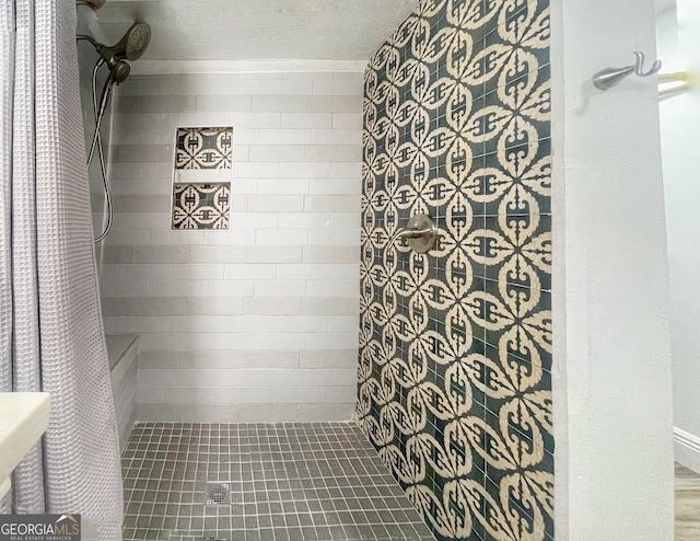 bathroom featuring a textured ceiling and a shower with curtain