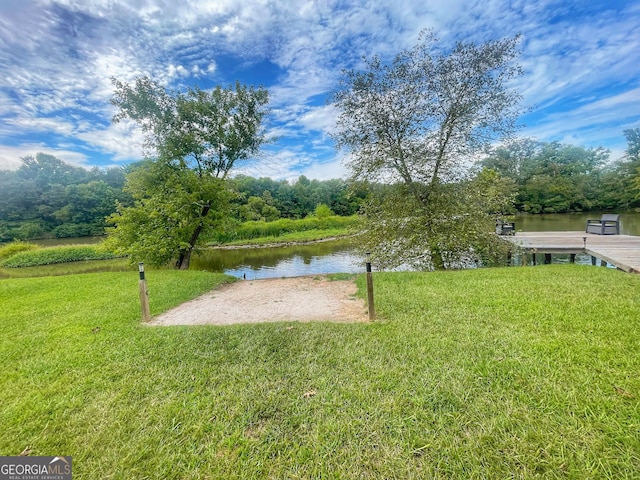 view of yard featuring a boat dock and a water view