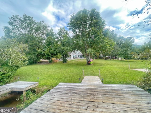 dock area featuring a yard and a deck