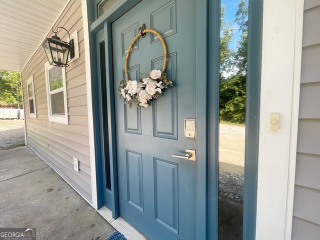 doorway to property featuring covered porch