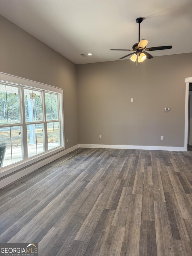 unfurnished room with dark wood-type flooring and ceiling fan