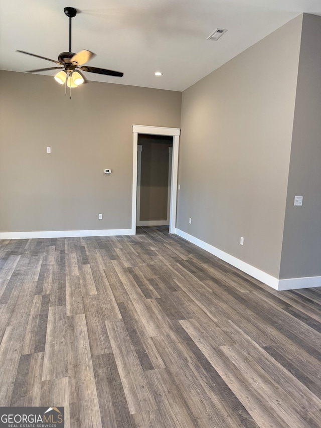 spare room featuring dark hardwood / wood-style flooring and ceiling fan